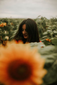 Young woman standing at sunflower farm