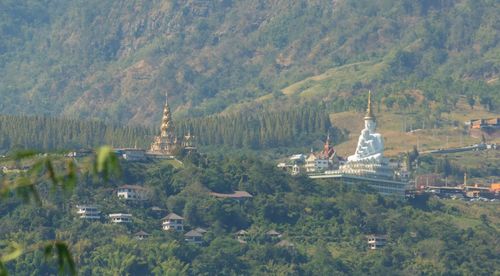 Panoramic view of trees and mountains against sky