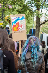 Rear view of people against graffiti in city