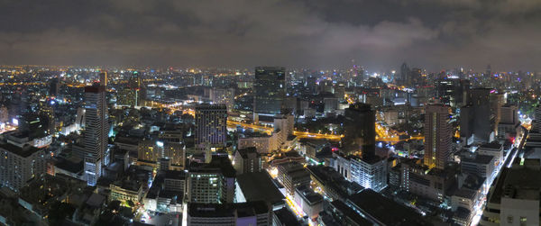 Aerial view of city lit up at night