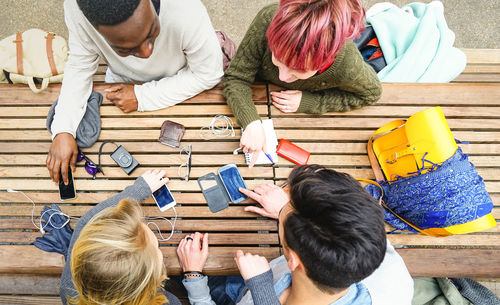 High angle view of people sitting on table