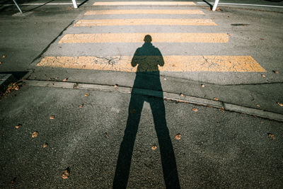 High angle view of man shadow on road