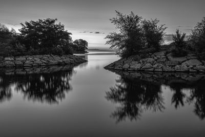 Reflection of trees in lake against sky