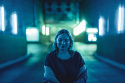 Portrait of woman standing at night