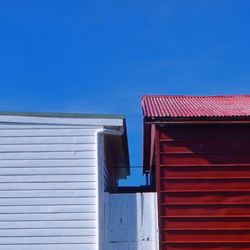 Low angle view of buildings against clear blue sky