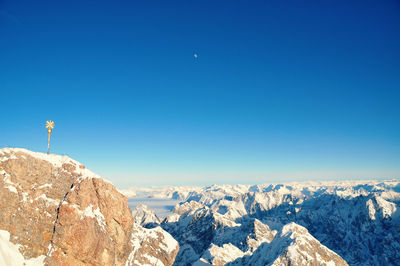 Scenic view of mountains against clear blue sky