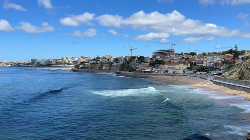 Panoramic view of beach and buildings against sky