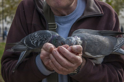 Midsection of man holding hands