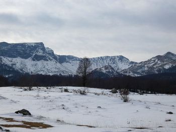 Scenic view of snow covered mountains against sky