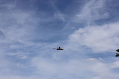 Low angle view of airplane flying in sky