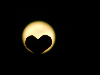 Close-up of heart shape over black background