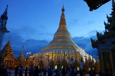 People at temple against sky