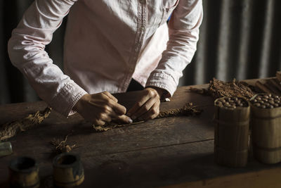 Midsection of man working on table