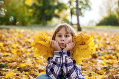 Portrait of girl with yellow leaves