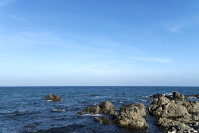 Scenic view of sea against blue sky