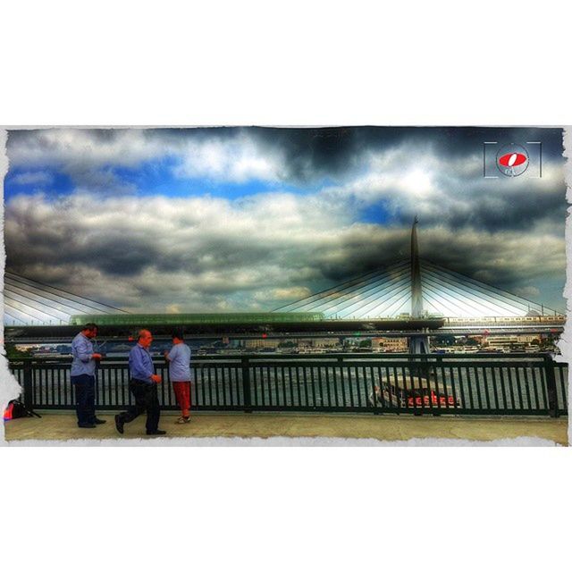 sky, built structure, architecture, transfer print, cloud - sky, auto post production filter, cloudy, building exterior, railing, weather, overcast, men, flag, water, lifestyles, cloud, sea, standing, person