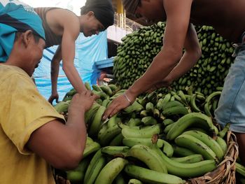 Midsection of man and woman at market stall