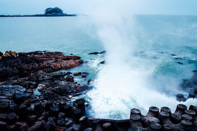 Waves splashing on rocks at shore