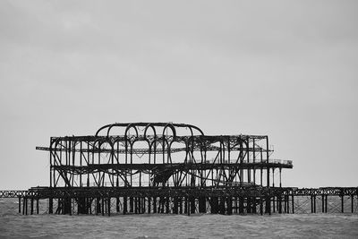 Silhouette pier on sea against clear sky