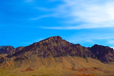 Scenic view of mountains against blue sky