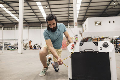 Engineer examining forklift in factory