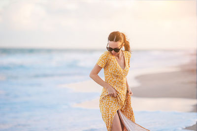 Young woman standing at beach