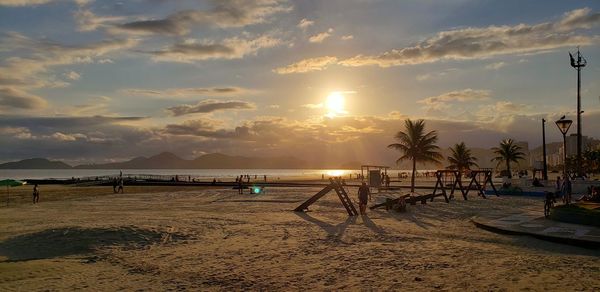 Scenic view of beach against sky during sunset