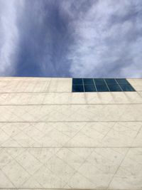 Low angle view of building against cloudy sky