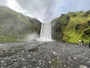 Scenic view of waterfall against sky