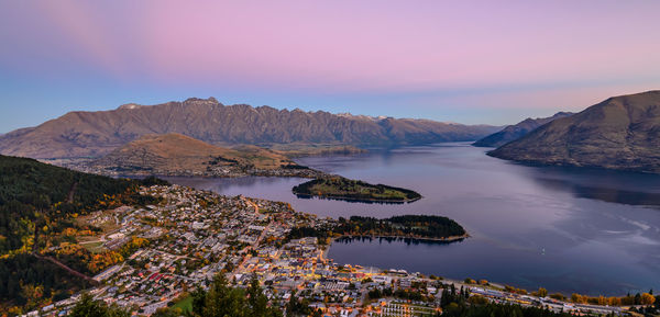 Scenic view of lake by mountains against sky