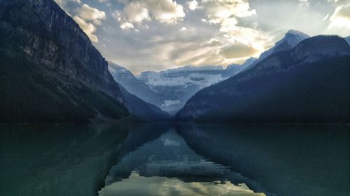 Scenic view of mountains against cloudy sky