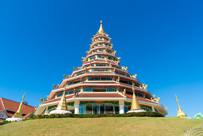 Low angle view of temple against clear blue sky