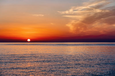 Scenic view of sea against romantic sky at sunset