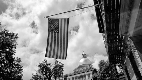 Low angle view of buildings and trees against sky