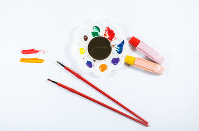 High angle view of multi colored pencils on white background