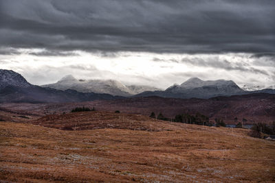 Scenic view of mountains against cloudy sky