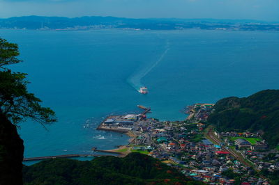 High angle view of sea and cityscape against sky