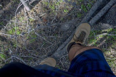 Low section of man standing by tree