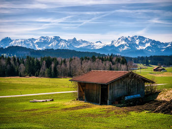 Scenic view of field and mountains against sky