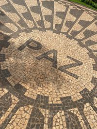 High angle view of shadow on tiled floor