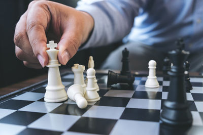 Close-up of man playing with chess