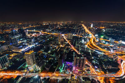 High angle view of illuminated buildings in city at night