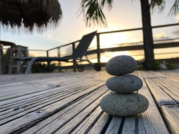 Close-up of stones on table against sky during sunset