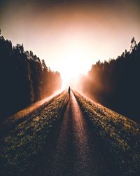 Road amidst landscape against sky during sunset