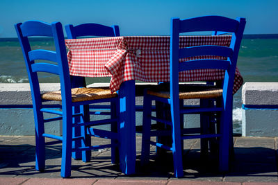 Chairs and tables against blue sky