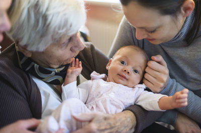 Old woman meeting her great granddaughter