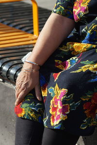 Midsection of woman with multi colored hands