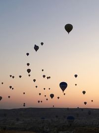 Hot air balloons flying in sky during sunset