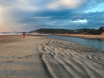 People on beach against sky