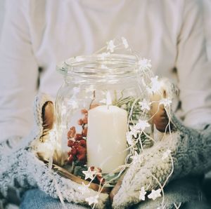 Midsection of person holding christmas candle